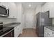 Clean kitchen with white cabinets, stainless steel appliances, and an adjacent hallway at 5611 Skinny Down, Charlotte, NC 28215