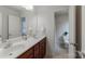 Bathroom featuring double sinks, tile floors, and views of the toilet and shower areas at 6414 Winding Creek Ln, Denver, NC 28037