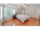 Bedroom with hardwood floors, tray ceilings and windows on two walls at 6414 Winding Creek Ln, Denver, NC 28037
