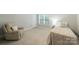 Spacious bedroom features a beige recliner chair and plenty of natural light at 6414 Winding Creek Ln, Denver, NC 28037