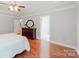 This bedroom boasts hardwood floors, recessed lighting, and access to the ensuite bathroom at 6414 Winding Creek Ln, Denver, NC 28037