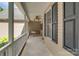 Relaxing covered porch featuring a porch swing and ceiling fan, perfect for enjoying the outdoors at 6414 Winding Creek Ln, Denver, NC 28037