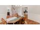 Open concept dining area with hardwood floors, a view of the staircase, and kitchen at 6414 Winding Creek Ln, Denver, NC 28037