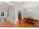 Elegant dining area with hardwood floors that leads into a kitchen with stainless appliances at 6414 Winding Creek Ln, Denver, NC 28037