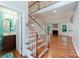 Spacious entryway with hardwood floors, staircase, and view into the living area at 6414 Winding Creek Ln, Denver, NC 28037