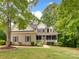 Charming two-story home with a cozy front porch and well-manicured lawn and mature landscaping at 6414 Winding Creek Ln, Denver, NC 28037
