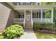 Charming home featuring a covered porch, brick steps, and mature landscaping, creating inviting curb appeal at 6414 Winding Creek Ln, Denver, NC 28037