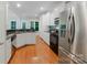 Modern kitchen with stainless steel appliances, granite countertops, and ample cabinet space at 6414 Winding Creek Ln, Denver, NC 28037