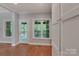 Sitting room with hardwood floors, a window, and access to the screened in porch at 6414 Winding Creek Ln, Denver, NC 28037