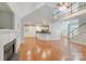 Open concept living room with fireplace, vaulted ceilings, and an attached kitchen with breakfast bar at 6414 Winding Creek Ln, Denver, NC 28037