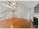 Spacious living room featuring a fireplace, vaulted ceiling, hardwood floors, and large windows at 6414 Winding Creek Ln, Denver, NC 28037