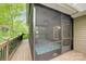 A large screened-in porch and deck area offer a relaxing outdoor space overlooking lush greenery at 6414 Winding Creek Ln, Denver, NC 28037