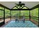 Inviting screened porch with ceiling fan, stylish rug, comfortable seating, and a peaceful wooded view at 6414 Winding Creek Ln, Denver, NC 28037