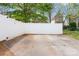Spacious concrete patio area with a tall white fence, providing privacy and ample outdoor space at 6603 Park Meadows Pl, Huntersville, NC 28078