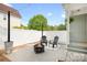Backyard patio with a fire pit, seating, string lights, and a white fence at 6603 Park Meadows Pl, Huntersville, NC 28078