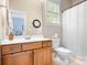 Bathroom with a wooden vanity, white countertop, toilet, and a shower with a white curtain at 6603 Park Meadows Pl, Huntersville, NC 28078