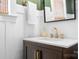 Elegant powder room with a dark wood vanity, gold fixtures, and modern decor at 6603 Park Meadows Pl, Huntersville, NC 28078