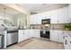 Bright kitchen featuring white cabinets, stainless steel appliances, and a neutral countertop at 6603 Park Meadows Pl, Huntersville, NC 28078