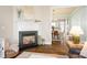 Bright living room featuring a fireplace, hardwood floors, and views into the adjacent dining and kitchen areas at 6603 Park Meadows Pl, Huntersville, NC 28078