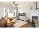 Comfortable living room features a fireplace, hardwood floors, large windows, and an entertainment center at 6603 Park Meadows Pl, Huntersville, NC 28078