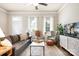 Inviting living room with a comfortable sofa, chairs, large windows, hardwood floors, and a stylish decor at 6603 Park Meadows Pl, Huntersville, NC 28078