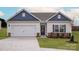Charming single-story home with a two-car garage, stone accents, and well-manicured lawn at 7015 Jerimoth Dr, Charlotte, NC 28215