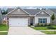 Charming single-Gathering home with brick and siding accents, a two-car garage, and a well-manicured front yard at 7015 Jerimoth Dr, Charlotte, NC 28215