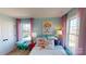 Bright bedroom featuring colorful accents, natural light from the windows, and playful decor at 7016 Butternut Oak Ter, Huntersville, NC 28214