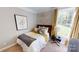 Cozy bedroom with a full-sized bed, stylish decor, a nightstand, and a window with natural light at 7016 Butternut Oak Ter, Huntersville, NC 28214