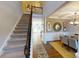 Inviting foyer with staircase leading to dining room featuring elegant decor and ample natural light at 7016 Butternut Oak Ter, Huntersville, NC 28214
