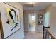 Bright hallway featuring neutral walls, carpet flooring, and view into a bathroom with window at 7016 Butternut Oak Ter, Huntersville, NC 28214