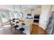 Modern kitchen with granite countertops, stainless steel appliances, an island with seating, and hardwood floors at 7016 Butternut Oak Ter, Huntersville, NC 28214