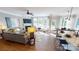Open-concept living room featuring a fireplace, large windows, comfortable seating, and access to the kitchen at 7016 Butternut Oak Ter, Huntersville, NC 28214