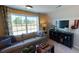 Comfortable living room featuring a large window, plush seating, and stylish decor elements at 7016 Butternut Oak Ter, Huntersville, NC 28214