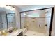 Tiled shower featuring a bench, built-in niche, and glass door enclosure at 7016 Butternut Oak Ter, Huntersville, NC 28214