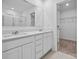 Modern bathroom showcasing a dual sink vanity, a large mirror, and a walk-in closet, providing ample space at 706 Olde England Dr, Lincolnton, NC 28092