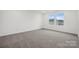 Well-lit bedroom with neutral carpet and windows, ready for personalization at 706 Olde England Dr, Lincolnton, NC 28092