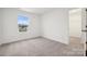 Comfortable carpeted bedroom with a sunny window and convenient closet access at 706 Olde England Dr, Lincolnton, NC 28092