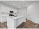 Modern kitchen boasting white cabinets, stainless steel appliances, a stylish island, and sleek countertops at 706 Olde England Dr, Lincolnton, NC 28092