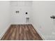Convenient laundry room with wood-style flooring and utility connections at 706 Olde England Dr, Lincolnton, NC 28092