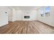 Bright living room with wood floors, a modern fireplace and plenty of natural light at 706 Olde England Dr, Lincolnton, NC 28092