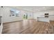 Open living space featuring hardwood floors, large windows, and a modern kitchen, creating a seamless flow at 706 Olde England Dr, Lincolnton, NC 28092