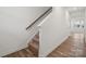 Clean stairway with carpeted steps, a wooden handrail, and stylish wood floors, inviting to upper floors at 706 Olde England Dr, Lincolnton, NC 28092