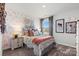 Bright bedroom with unique wallpaper, a comfortable bed, and ample natural light at 711 Olde England Dr, Lincolnton, NC 28092