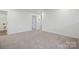 Bright bedroom with neutral carpet, white walls, and two doors at 714 Olde England Dr, Lincolnton, NC 28092