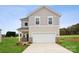 Two-story home featuring neutral siding, brick accents, attached two-car garage, and a well-manicured lawn at 714 Olde England Dr, Lincolnton, NC 28092
