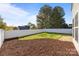 Landscaped backyard featuring a well-maintained lawn, privacy fence, mulch beds, and a patio at 7262 April Mist Trl, Huntersville, NC 28078