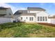 Spacious backyard featuring a well-maintained lawn, privacy fence, and patio area at 7262 April Mist Trl, Huntersville, NC 28078