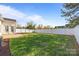 Spacious backyard featuring a well-maintained lawn, privacy fence, and patio area at 7262 April Mist Trl, Huntersville, NC 28078