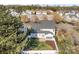 Aerial view of a home with a fenced backyard and a patio, surrounded by mature trees at 7262 April Mist Trl, Huntersville, NC 28078